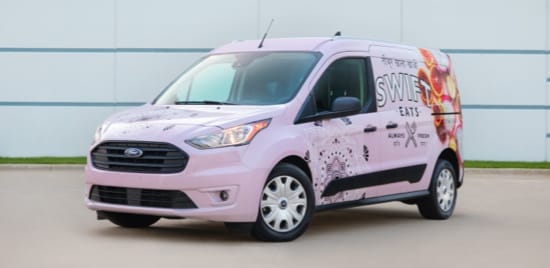 A white fleet van with company branding.
