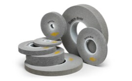 An assortment of Scotch-Brite™ EXL PRO Deburring Wheels of different sizes.