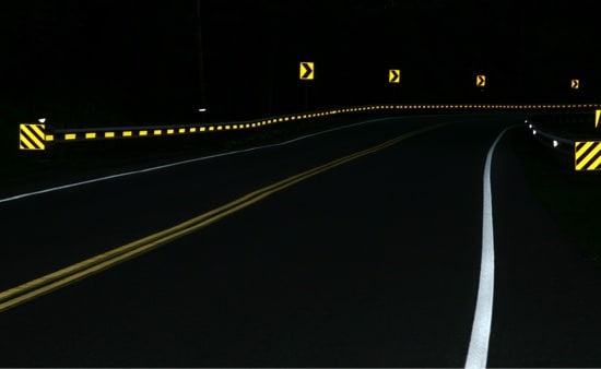 A bend in a rural road at night.
