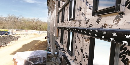 Building under construction with 3M-branded protective wrap on the exterior wall.
