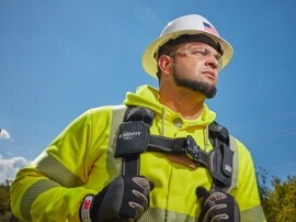 A utility worker wearing a hard hat and reflective shirt.