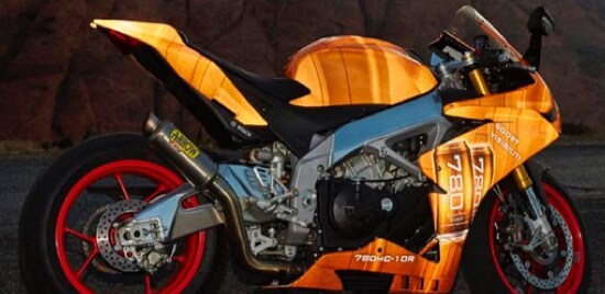 A motorcycle wrapped in orange 3M™ Scotchlite™ Reflective Graphic Film.
