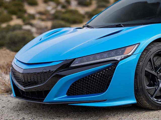 Close up of sports car front hood area with ocean shimmer blue colour wrap film.
