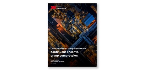 The cover of a brochure showing an overhead view of a complex industrial plant lit up at night. 
