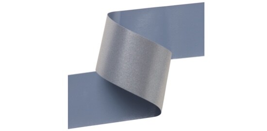 A strip of reflective transfer film with a silver front and a grey adhesive back.
