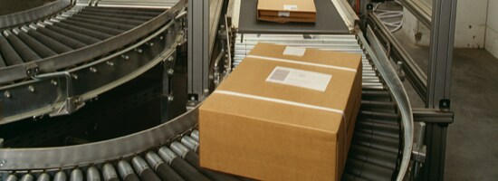 Sealed boxes moving along a conveyor.
