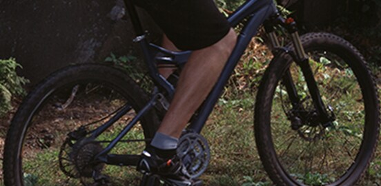 Homme à vélo sur l’herbe.
