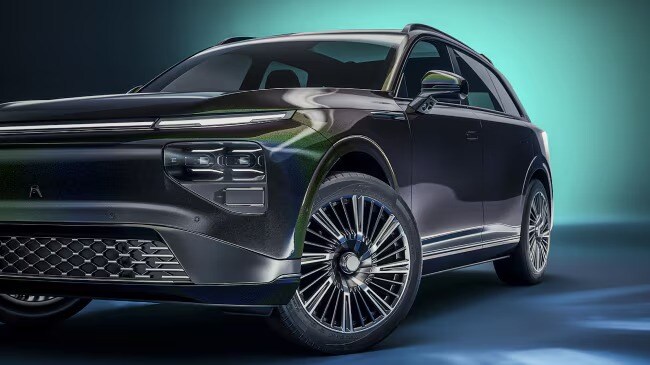 Profile view of a glossy black SUV with clean lines.
