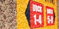 A sidewalk with a yellow and red graphic on it.
