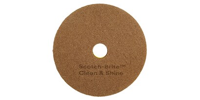Large, brown circular commercial cleaning and shining pad.
