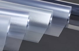 Cinq rouleaux de pellicules protectrices transparentes.