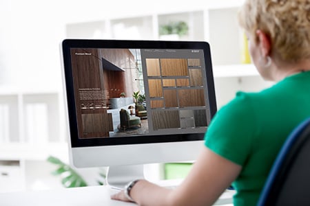 Individual using desktop computer to browse interactive catalog.
