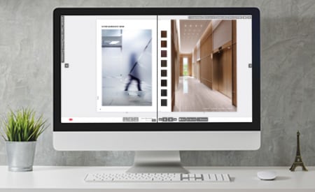 Desktop computer monitor with image of interactive catalog featuring pages with glass and surface finishes.
