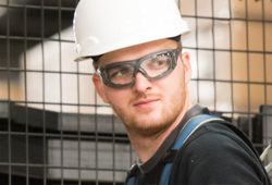 Worker turning wearing 3M's state of the art protective eyewear.
