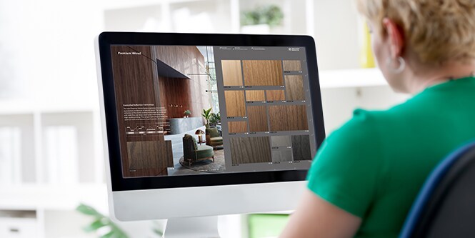 Individual using desktop computer to browse interactive catalog.
