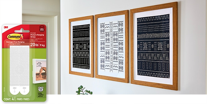 White wall with 3 large pictures hung using extra large item picture hanging strips.
