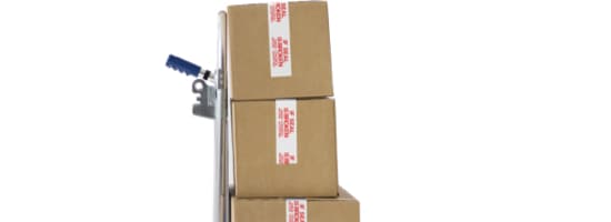 Trois boîtes scellées sur un chariot manuel.