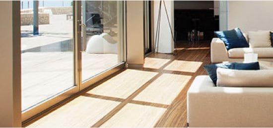 A living room floor with the sunshine highlighting the floor.
