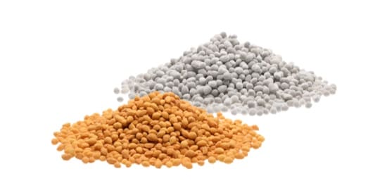 Two piles of beads - one orange and one white.
