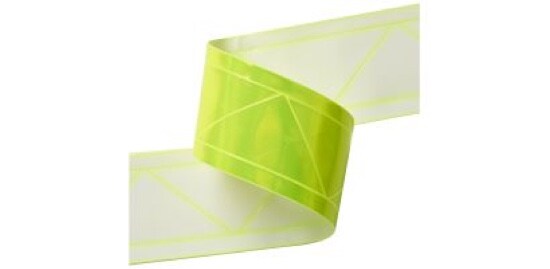 A strip of reflective high gloss material with a retroreflective green front and a white back.
