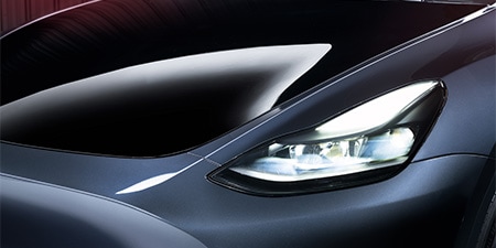 Close up of a sleek car hood wrapped in PPF preserving gloss and matte finishes.
