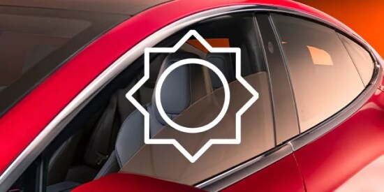 Icon of the sun overlayed on a real car window with tint film.
