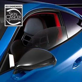 Exterior driver side close-up view of Ceramic IR window tint featuring Skin Cancer Foundation recommendation logo.