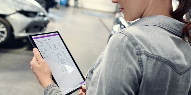 Une femme qui regarde une tablette.
