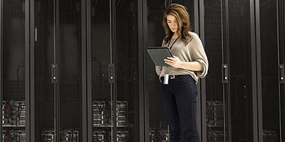 Mixed Race Businesswoman Using Tablet in Server Room
