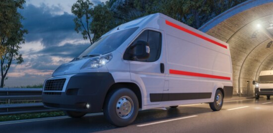 Line of parked vans with highly visible, reflective conspicuity tape.
