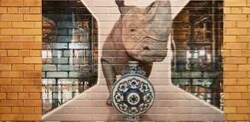 A brick wall with a decorative film of a rhinoceros.
