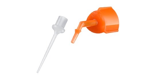 A clear tip and an orange tip used on a dental cement syringe.
